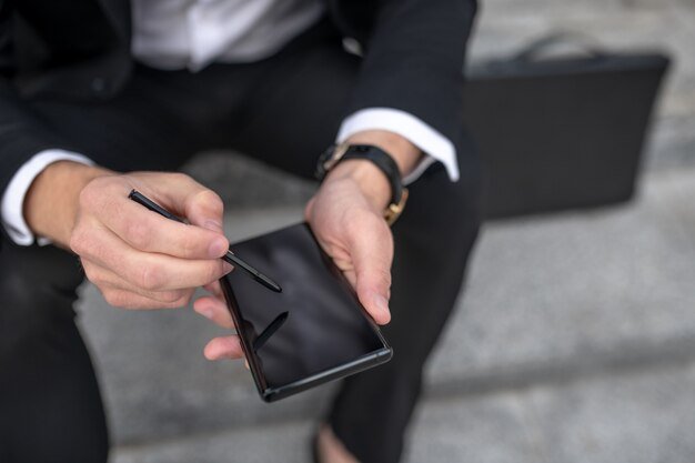 close-up-picture-businessman-writing-message-smartphone_259150-7962 Introduction to Gucci Wallets: The Appeal of Luxury Fashion and Accessories